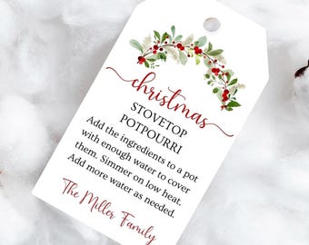 May include: A white tag with a Christmas stovetop potpourri recipe. The tag has a watercolor floral design with red berries and green leaves. The text includes instructions and "The Miller Family".