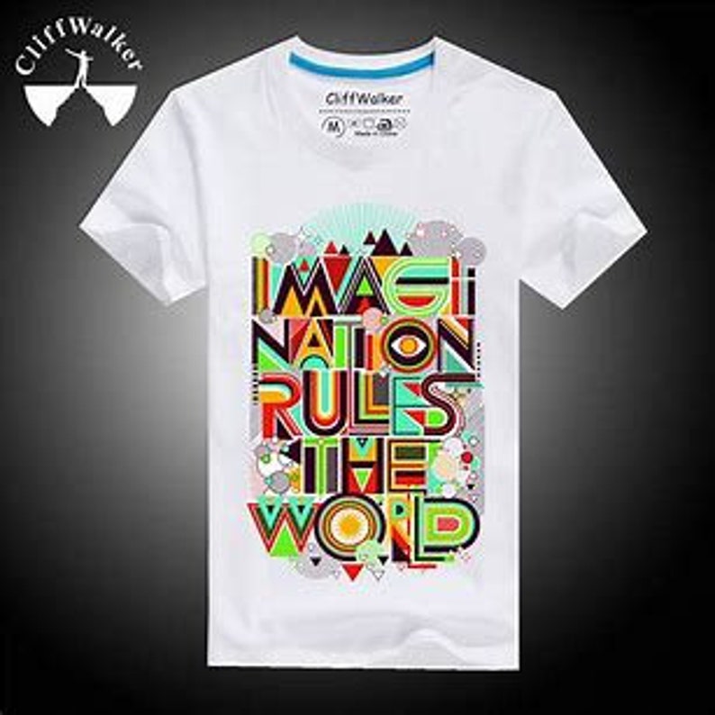 May include: White t-shirt with a colourful graphic print that says "Imagination Rules the World".