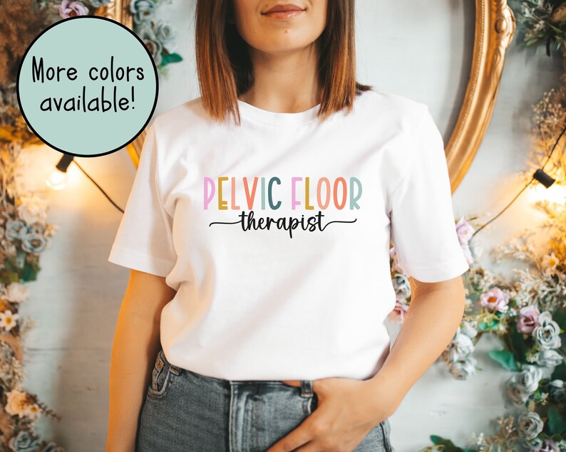 May include: White t-shirt with the text "PELVIC FLOOR therapist" in rainbow colors.