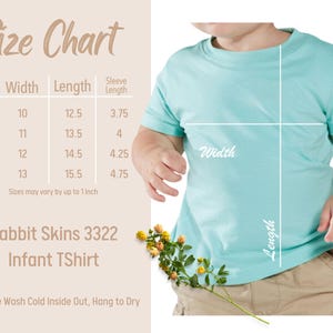 May include: A light blue infant t-shirt with a size chart. The chart shows measurements for sizes 6M to 24M, with widths from 10 to 13 inches and lengths from 12.5 to 15.5 inches. The shirt is Rabbit Skins 3322.