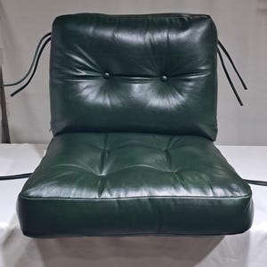 Custom dark green leather cushion with button-tufted backrest, featuring secure tie straps for easy attachment. Made from premium real leather, this cushion offers comfort, durability, and a luxurious feel, perfect for enhancing indoor  seating.