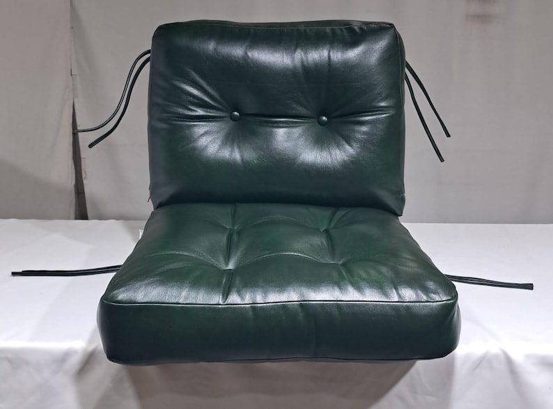Custom dark green leather cushion with button-tufted backrest, featuring secure tie straps for easy attachment. Made from premium real leather, this cushion offers comfort, durability, and a luxurious feel, perfect for enhancing indoor  seating.