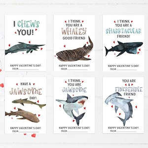 May include: Valentine's Day cards with watercolor illustrations of sharks and other sea creatures. Each card has a punny message like "I CHEWS YOU!" and "You are a FINCREDIBLE friend!" with space to write "Happy Valentine's Day From:"