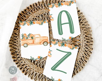 May include: Printable orange and green banner with the letters A and Z and a truck with oranges in the bed. The banner is on a woven brown placemat.