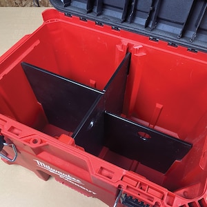 May include: Red Milwaukee Packout tool box with black dividers inside. The dividers create multiple compartments for organising tools.