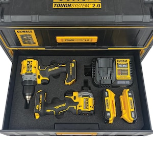 May include: A black and yellow DeWalt ToughSystem 2.0 tool case containing a black and yellow drill, a black and yellow impact driver, a black and yellow battery charger, and two black and yellow batteries.