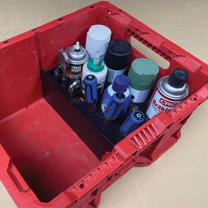 May include: A red plastic storage tote with a black organizer insert. The tote contains various spray paint cans, including a can labeled "CRC Brake Parts Cleaner", and several screwdrivers.