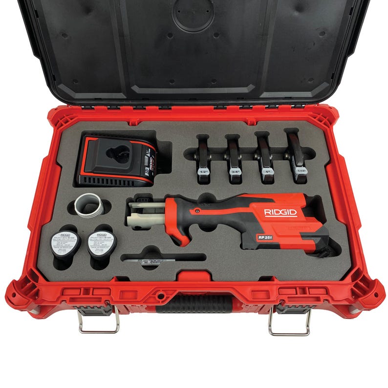 May include: Open red toolbox containing a black and red Ridgid RP 251 tool, battery charger, and various fittings. The toolbox is open, revealing the tools nestled in a gray foam insert. The Ridgid tool is prominently displayed.