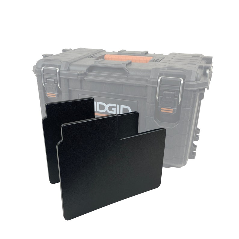 May include: Two black plastic dividers for a toolbox. The dividers are designed to fit inside a toolbox to help organize tools and supplies.