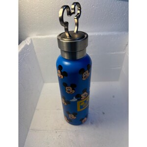 May include: Blue stainless steel water bottle with a Mickey Mouse head lid and a pattern of Mickey Mouse faces on the bottle.