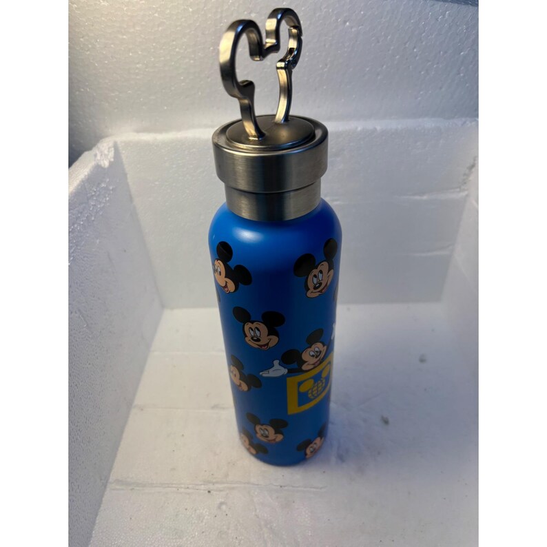 May include: Blue stainless steel water bottle with a Mickey Mouse head lid and a pattern of Mickey Mouse faces on the bottle.