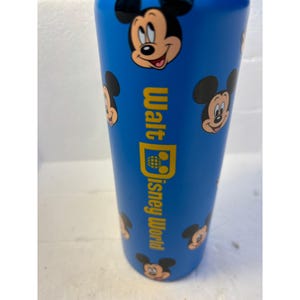 May include: Blue water bottle with a repeating pattern of Mickey Mouse heads and the text "Walt Disney World" in yellow.