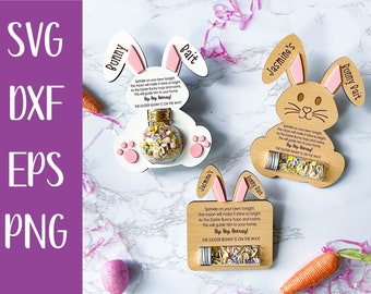May include: Two wooden bunny-shaped Easter treat holders with a small glass jar filled with colorful sprinkles. The holders are decorated with pink ears and paw prints. The text on the holders reads "Bunny Bait" and "Jasmine's Bunny Bait".