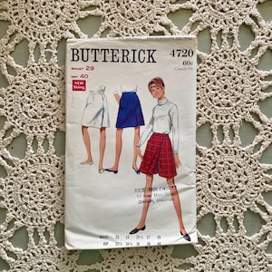 May include: Vintage sewing pattern for a skirt, Butterick pattern number 4720, size 29 waist and 40 hip. The pattern includes instructions for making a skirt with a variety of fabrics. The pattern is in good condition and includes the original envelope.