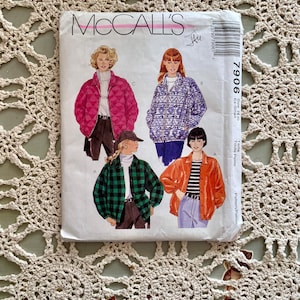 May include: McCall's sewing pattern envelope for a jacket. The envelope shows four different versions of the jacket, including a quilted jacket, a patterned jacket, a plaid jacket, and a solid jacket. The pattern number is 7906.