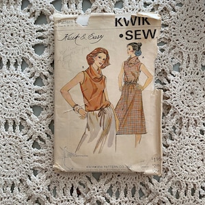 May include: Vintage Kwik & Easy sewing pattern featuring illustrations of two women's outfits. The pattern includes a cowl neck top and a dress with a plaid pattern. The pattern size is 6-8-10-12.