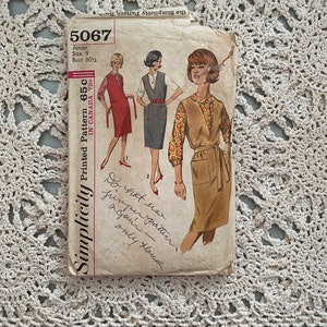 May include: Vintage Simplicity sewing pattern number 5067 for a junior size 9 dress with a bust measurement of 30 1/2 inches. The pattern includes three different styles of dresses, all with a sleeveless vest.