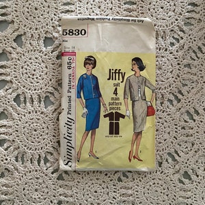 May include: Simplicity sewing pattern number 5830 for a Jiffy suit. The pattern is for a size 14 bust and includes 4 main pattern pieces. The pattern is printed on a yellow background with a white border.
