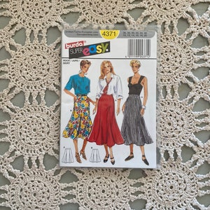 May include: Burda Style sewing pattern number 4371 for a skirt. The pattern includes three different skirt styles: a floral print skirt, a red skirt, and a black and white striped skirt. The pattern is for sizes 36-46 (US sizes 10-20).