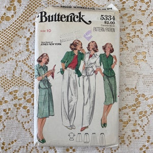 May include: Vintage sewing pattern for a women's skirt and blouse. The pattern is from Butterick and is size 10. The pattern is for a skirt and blouse with a checked pattern. The pattern is from the 1970s.