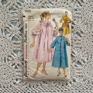 May include: Vintage Simplicity sewing pattern for a women's nightgown. The pattern is for sizes 12 and bust 30. The pattern is printed on a white paper with a blue and white floral design. The pattern is titled "Simplicity Printed Pattern 40c".