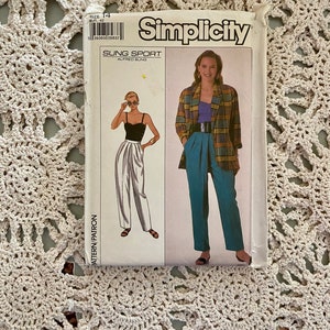 May include: Simplicity sewing pattern for a pair of trousers with a high waist and a loose fit. The pattern is for size 14 and is called "Sung Sport" by Alfred Sung.