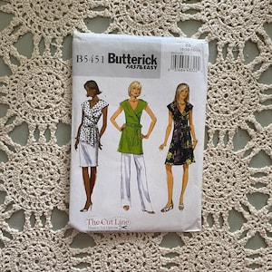 May include: A sewing pattern for a dress with three different styles. The pattern is from Butterick, and the pattern number is B5451. The pattern is for sizes 8-10-12-14.