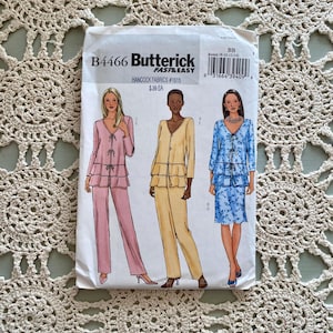May include: A sewing pattern envelope for a women's trouser suit. The pattern is for sizes 8-10-12-14. The envelope shows three different versions of the trouser suit: one in pink, one in yellow, and one in blue with a floral print. The pattern is from Butterick and is part of their Fast & Easy line. The pattern number is B4466.