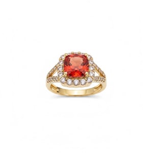 May include: A gold ring featuring a central cushion-cut orange gemstone surrounded by a halo of small clear round stones. The band is split into two sections on each side, with additional small clear stones set along the shoulders of the ring.