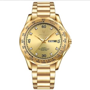 May include: A gold-tone analog wristwatch with a matching metal link band. The round face features a gold dial with crystal hour markers, luminous hands, a day-date window at the three o'clock position, and a tachymeter bezel with black markings.
