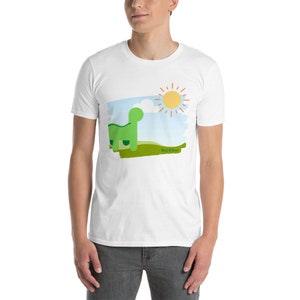 May include: White t-shirt with a green dinosaur, a blue sky, and a yellow sun with orange rays. The text "Hello There" is printed on the shirt.
