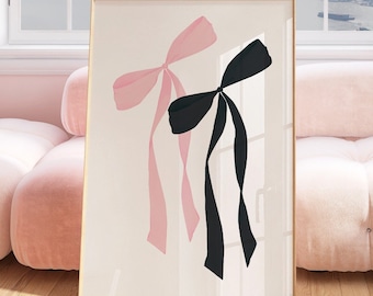 May include: A framed print of two large bows, one pink and one black, against a white background.