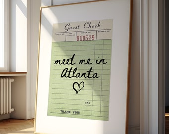 May include: A framed print featuring a vintage guest check design. The text reads "meet me in Atlanta" with a heart symbol. The check number is 800529.