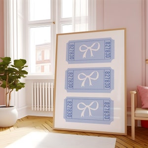 May include: A framed print with three blue tickets featuring white bows and the number 827830 on each ticket.