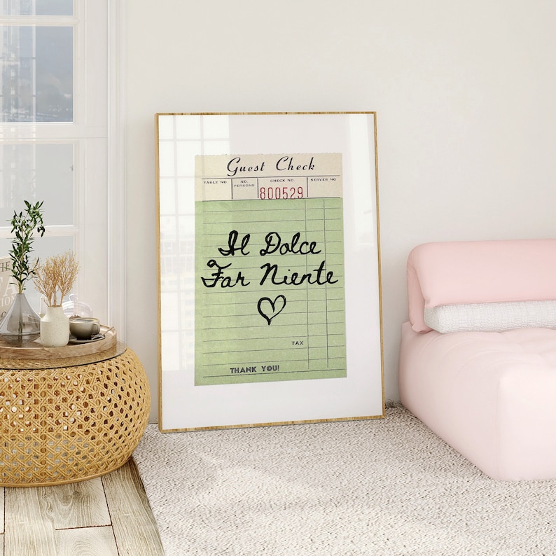 May include: A framed print of a vintage guest check with the text "Il Dolce Far Niente" written in cursive and a heart symbol. The check number is 1800529.