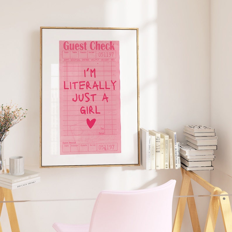 K&ouml;nnte beinhalten: Ein gerahmter rosa-wei&szlig;er Druck eines Gastchecks mit dem Text "I'm literally just a girl" in rosa. Das Datum auf dem Scheck ist 051197.
