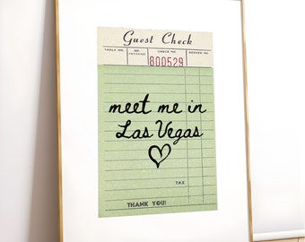 May include: A vintage-style guest check with green lines and a red check number. The check has the text "Guest Check" at the top and "Thank You!" at the bottom. The text "meet me in Las Vegas" is written in black cursive with a heart drawn below it.