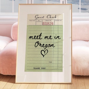 May include: A vintage-style guest check with green paper and black lines. The check has the text "Guest Check" at the top and "Thank You!" at the bottom. The check also has the text "meet me in Oregon" written in cursive with a heart symbol.