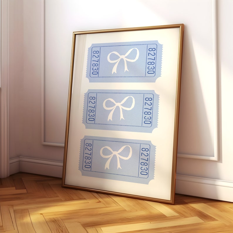 May include: A framed print with three blue tickets featuring a white bow on each ticket. The tickets have the number 827830 printed on them.