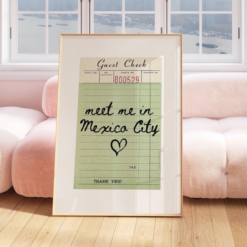 May include: A vintage-style guest check with a green background and black text. The check has a handwritten message that says "meet me in Mexico City" with a heart drawn below the text. The check number is 1800529.
