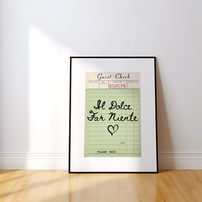 May include: A framed print of a vintage guest check with the text "Il Dolce Far Niente" written in cursive with a heart drawn below the text. The check number is 800529.