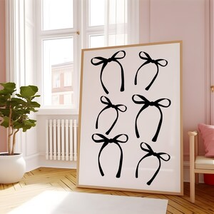 May include: A white canvas print with six black bow designs. The bows are arranged in a grid pattern.