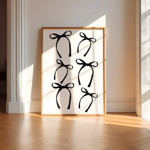 May include: A black and white print of a minimalist design featuring multiple stylized bows in a repeating pattern.