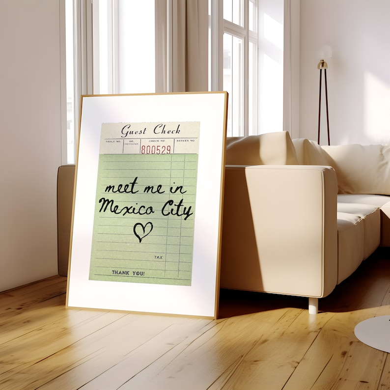 May include: A framed print of a vintage guest check with the text "meet me in Mexico City" written in black cursive with a heart drawn below the text. The check number is 800529.