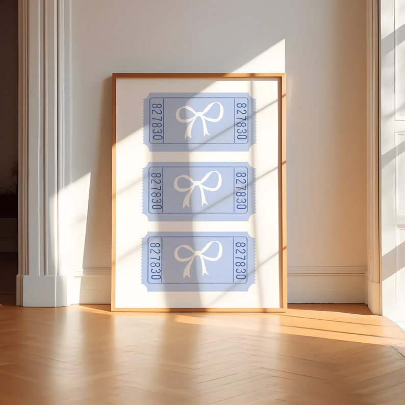 May include: Three blue ticket-shaped prints with white bows and the number 827830 printed on each. The prints are framed in a light wood frame.