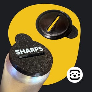 May include: A black plastic lid with a slot for sharps disposal. The lid is labeled "SHARPS" in white lettering. The lid is on top of a silver can.