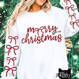May include: White sweatshirt with the text "merry christmas" in red script. Red bows are on the sleeves. The design includes the text "DO NOT COPY" and a black cat logo.