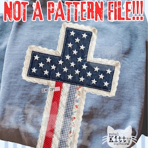 May include: Light blue sweatshirt with a cross design. The cross is made of denim with white star accents, lace trim, and patterned ribbons. The text "NOT A PATTERN FILE!!!" is at the top. The words "DO NOT COPY" are on a small tag.