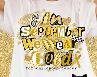 May include: A white t-shirt featuring a graphic design with the text In September We Wear Gold for childhood cancer. The design includes gold and black lettering, a butterfly, hearts, stars, a checkered pattern, and a gold awareness ribbon.