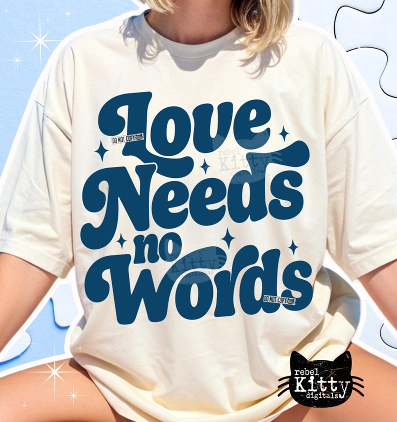 May include: Cream-colored t-shirt with the text "Love Needs no Words" in dark blue, stylized font. The design includes star accents and the words "DO NOT COPY" in small print. A black cat logo is visible at the bottom.